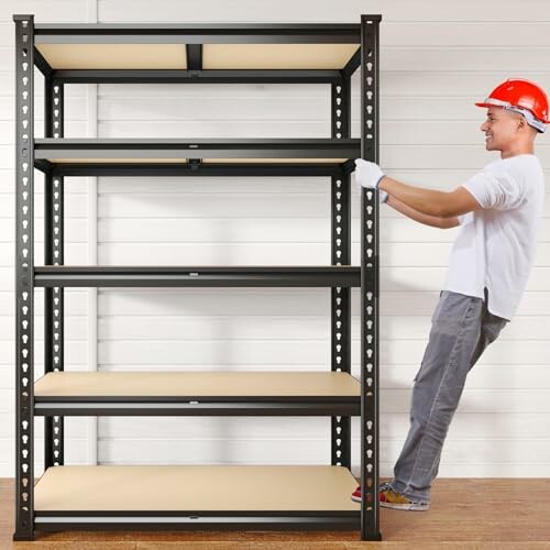 Worker in a red hard hat assembling metal shelving unit.